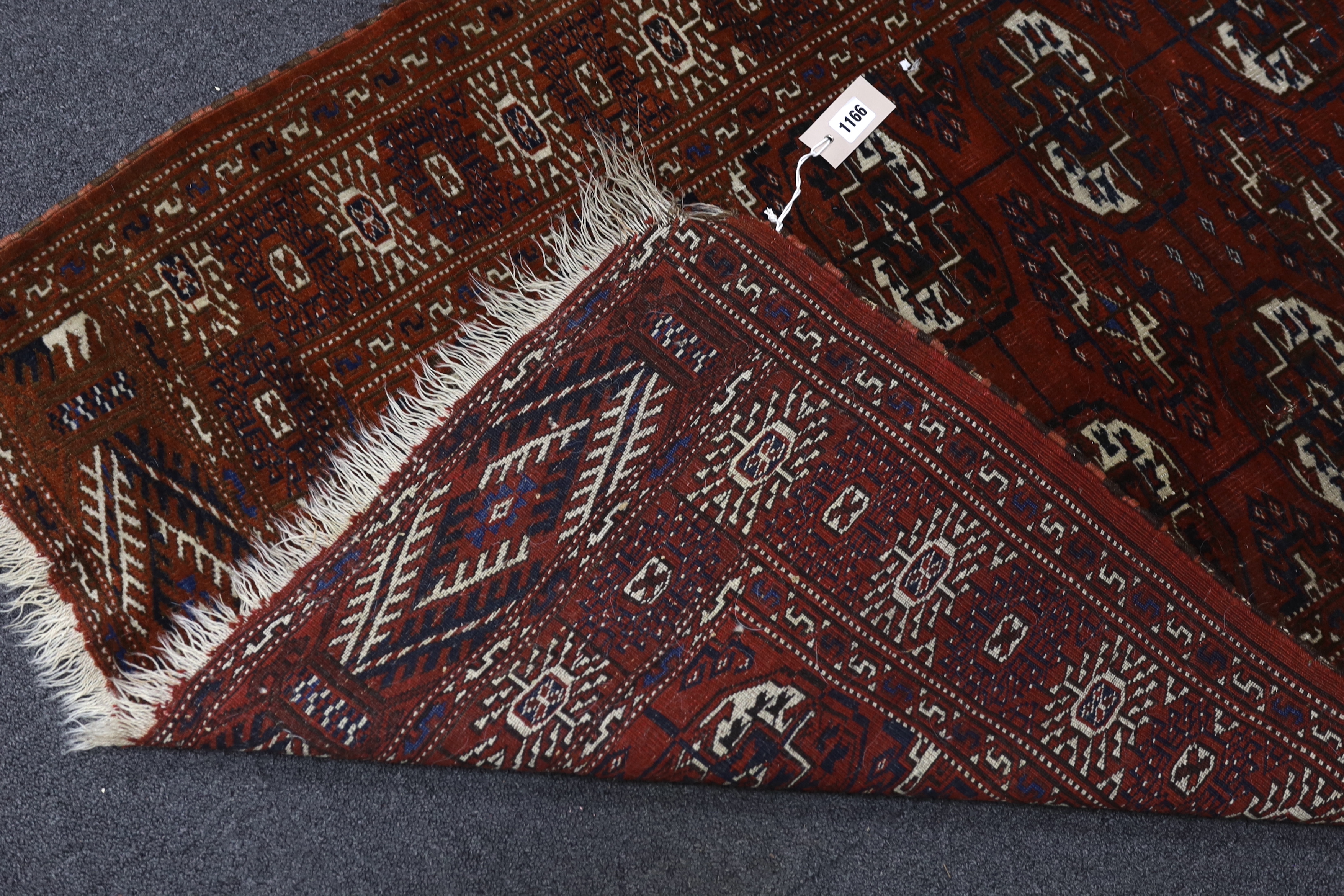A Turkeman burgundy ground rug, 126 x 94cm